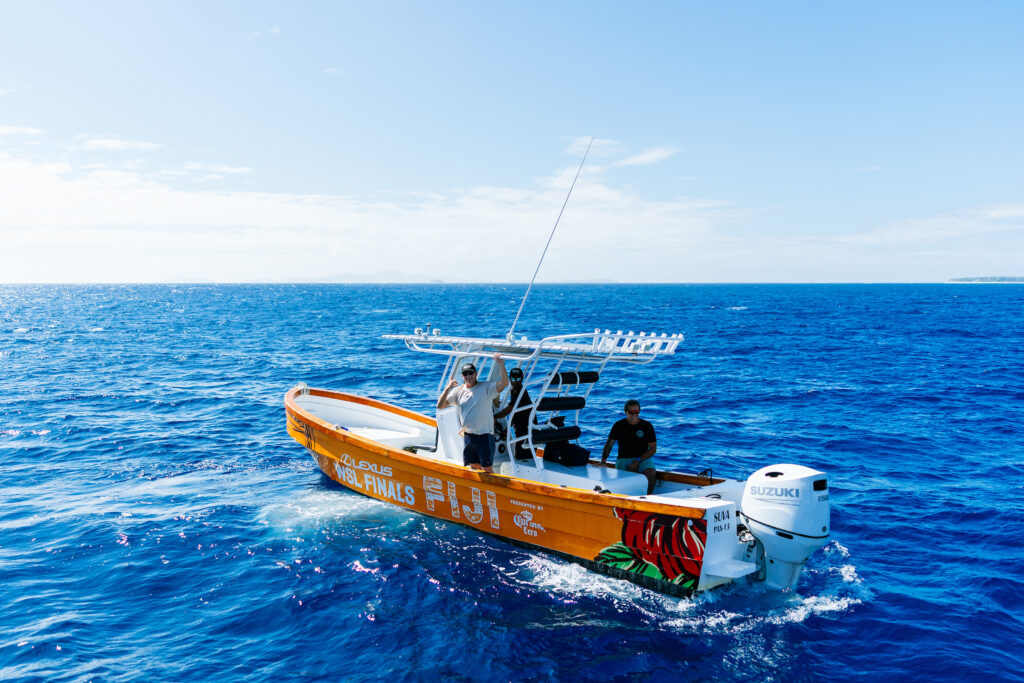 Surf boat speeding out to the reef, Fiji